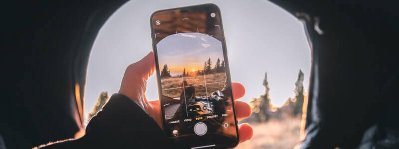 A person taking a picture with his cellphone. The image itself reflects the power of pictures, so it holds an important position in the SEO process for bloggers